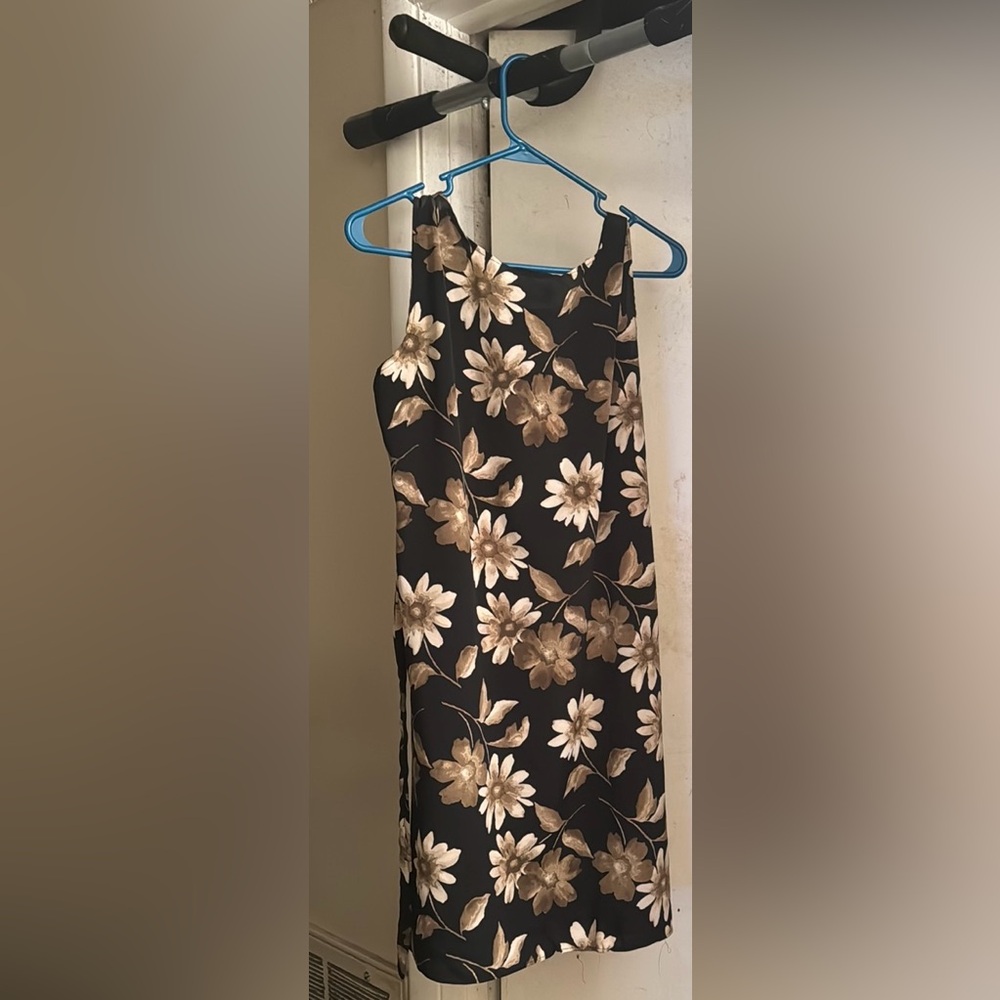 Black dress with gold flowers. Flows past the knees. Ties in the back